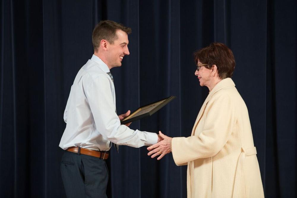GSA President shaking hands with faculty award recipient